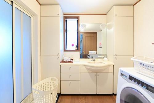 a bathroom with a sink and a washing machine at Nerima-ku - House / Vacation STAY 3889 in Tokyo