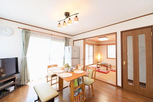 a living room with a dining room table and a kitchen at Nerima-ku - House / Vacation STAY 3889 in Tokyo