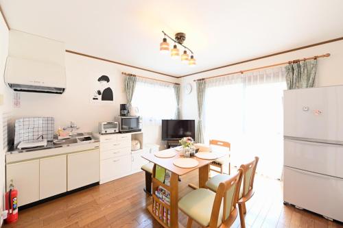 a kitchen with a table and chairs in a room at Nerima-ku - House / Vacation STAY 3889 in Tokyo