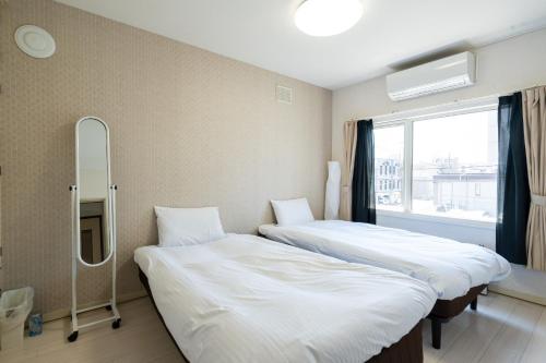 En eller flere senge i et værelse på ArcDream / Vacation STAY 4155