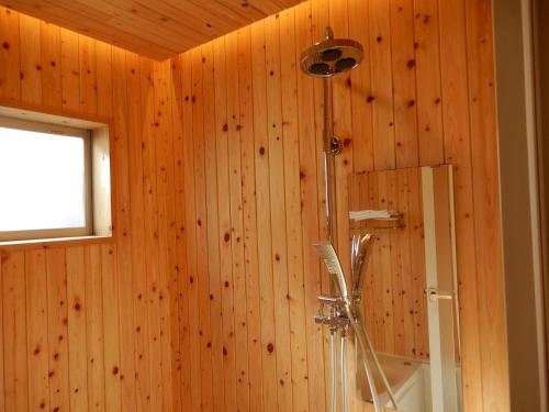 a bathroom with a shower in a wooden wall at Uruma - House - Vacation STAY 16594 in Uruma