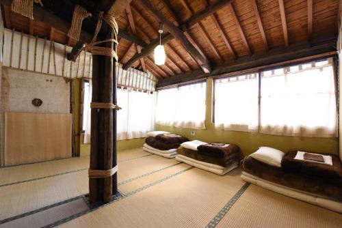 a room with three beds in it with windows at Tsukubo-gun - House / Vacation STAY 34603 in Hayashima