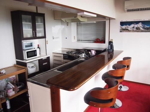 a kitchen with a wooden counter top and some chairs at Private - Villa - tsubasa- Vacation STAY 4192 in Kimitsu