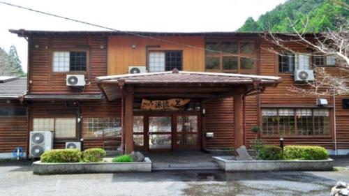 a wooden house with speakers in front of it at Nature Resort in Shimanto / Vacation STAY 33197 in Funato