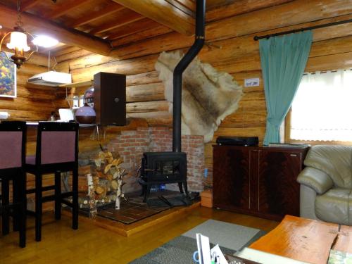 a living room with a fireplace in a log cabin at Kameda-gun - Cottage / Vacation STAY 34923 in Nanae
