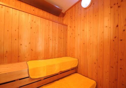 a sauna with a bench in a wooden wall at Nature Resort in Shimanto / Vacation STAY 33197 in Funato