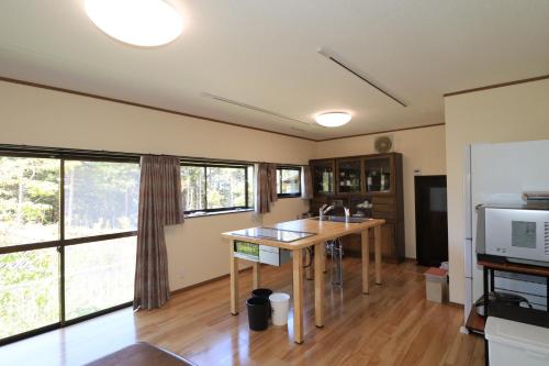 a kitchen with a table and some windows at Nakatsugawa - House / Vacation STAY 39303 in Nakatsugawa