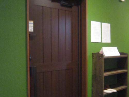 a door in a room with a green wall at Minato Oasis Numazu - Vacation STAY 31031v in Numazu