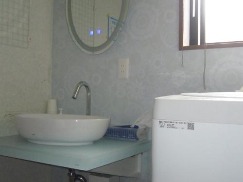a kitchen with a sink and a refrigerator at Minato Oasis Numazu / Vacation STAY 40706 in Numazu