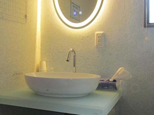 a sink in a bathroom with a mirror at Minato Oasis Numazu / Vacation STAY 40706 in Numazu