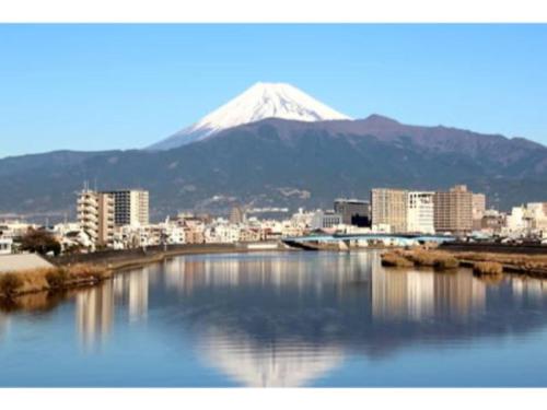a mountain in the background of a city and a river at Minato Oasis Numazu / Vacation STAY 40706 in Numazu