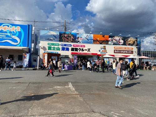 a group of people walking in a street with shops at Minato Oasis Numazu / Vacation STAY 40706 in Numazu
