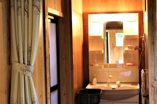 a bathroom with a sink and a mirror at Kumage-gun - House / Vacation STAY 39331 in Miyanoura
