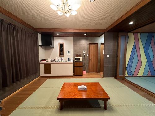 a living room with a table and a kitchen at Minato Oasis Numazu / Vacation STAY 40715 in Numazu