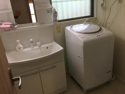 a bathroom with a washing machine and a sink at Nikko - House / Vacation STAY 40938 in Nikko