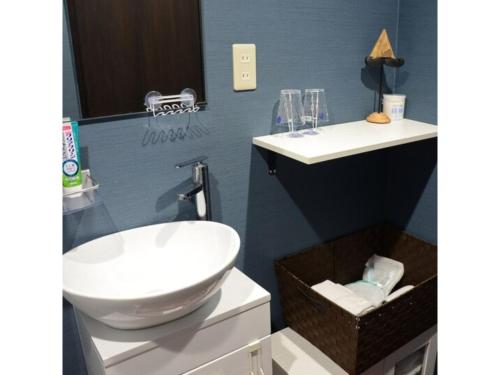 a bathroom with a white sink and two mirrors at Yokocho Building / Vacation STAY 42628 in Beppu