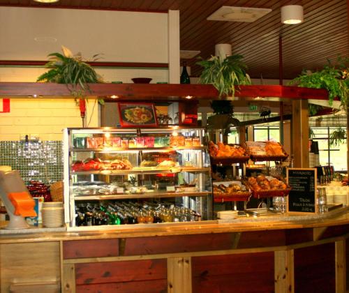 a bakery with a counter with food and pastries at Karjalan Kievari in Kesälahti