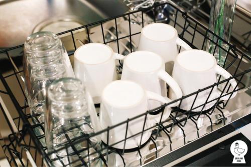 a drying rack filled with cups and glasses at Urakami #201 / Vacation STAY 41894 in Nagasaki