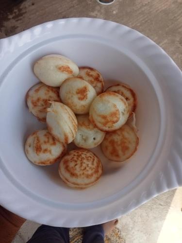 a white plate with a pile of small potatoes at New Vivek homestay Hampi in New Hampi