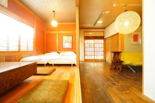 a large room with two beds and a fireplace at Private House IT / Vacation STAY 47911 in Takayama