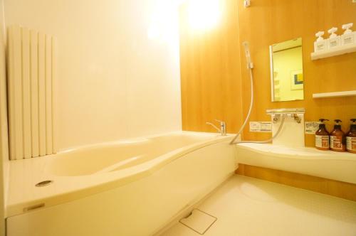 a bathroom with a bath tub and a sink at Private House IT / Vacation STAY 47911 in Takayama