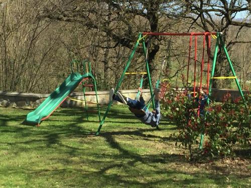 a person laying on a swing set in a yard at Spacious holiday home in Ambra