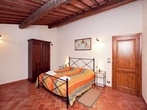 a bedroom with a bed and a wooden door at Spacious holiday home in Ambra