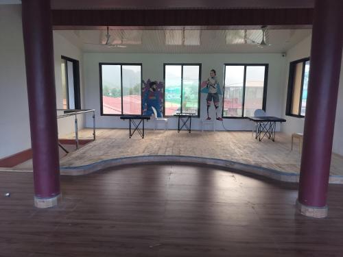 a room with two people standing in the middle of a dance floor at Sandalwoods Resort in Neral