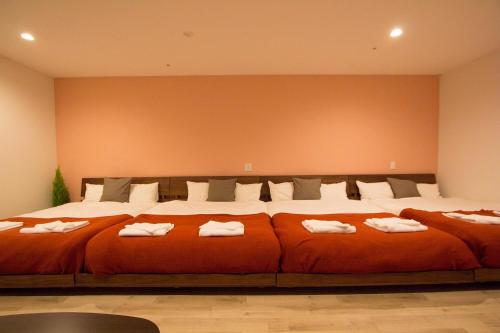a bedroom with a large bed with towels on it at SEVEN Building / Vacation STAY 4961 in Asahikawa