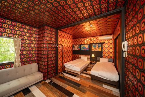 a room with two beds and a couch in it at Harbors - Vacation STAY 54826 in Beppu