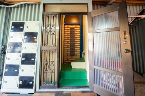 an entrance to a room with two doors and a staircase at Harbors - Vacation STAY 54826 in Beppu