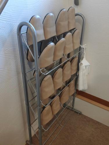a rack of white shoes in a wall at Ikuta / Vacation STAY 53359 in Haneda