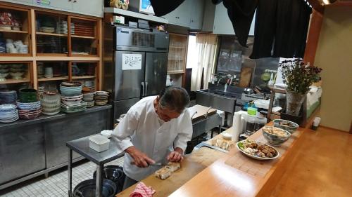 a man standing in a kitchen preparing food at Hidaka-gun - House - Vacation STAY 99266v in Haneda