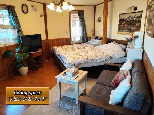 a living room with a bed and a couch at Eniwa - House - Vacation STAY 18354 in Eniwa