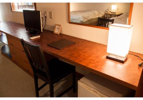 a desk with a computer and a monitor on it at Shozu-gun - House / Vacation STAY 53734 in Tonosho