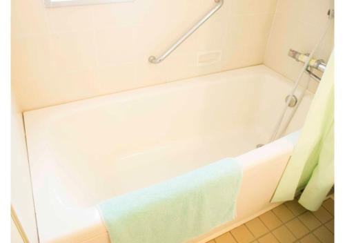 a bathroom with a bath tub with a towel on it at Shozu-gun - House / Vacation STAY 53734 in Tonosho
