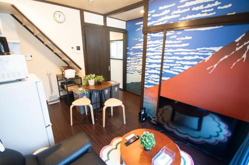 a living room with a table and a tv at Omori Tei大森亭OMT 18min to Haneda, 3min Omori, Max 7 people in Tokyo