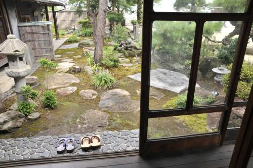 a window view of a garden from a house at Kanakuraen / Vacation STAY 5125 in Marugame
