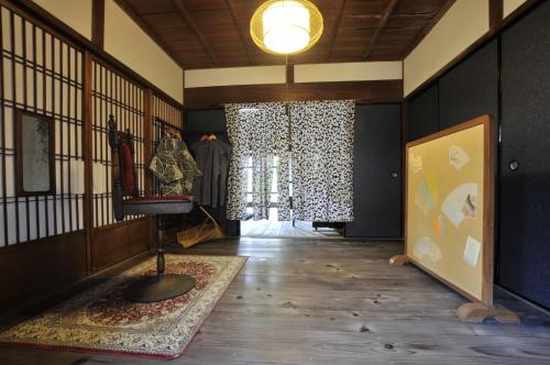 a hallway with a room with black walls and wooden floors at Kanakuraen / Vacation STAY 5125 in Marugame