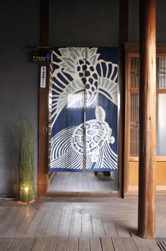 a door with a painting on the side of a building at Kanakuraen / Vacation STAY 5125 in Marugame