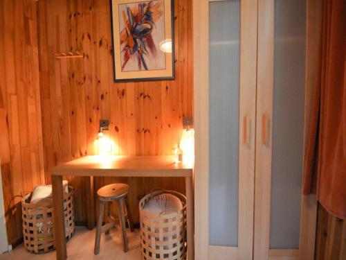 a small room with a table and two stools at Cozy Chalet with barbecue in Trou du Diable