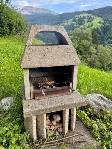 a stone oven sitting on top of a hill at Chesa Val in Saas