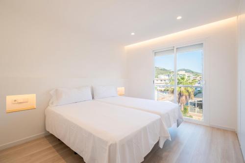 Ένα ή περισσότερα κρεβάτια σε δωμάτιο στο Apartamentos las palmeras 3