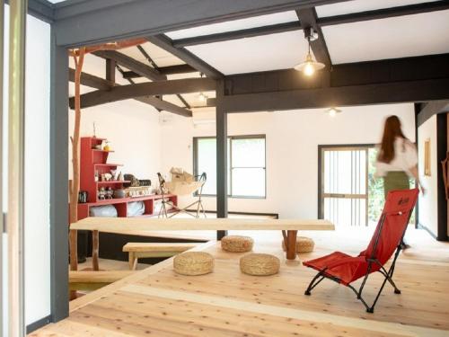 a room with a table and a red chair at Camp-style inn Yamagara - Vacation STAY 41883v in Iwai