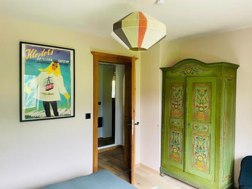 a room with a poster and a green cabinet at Chesa Val in Saas