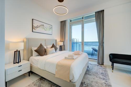 a bedroom with a large bed and a large window at Majestic Tower in Dubai