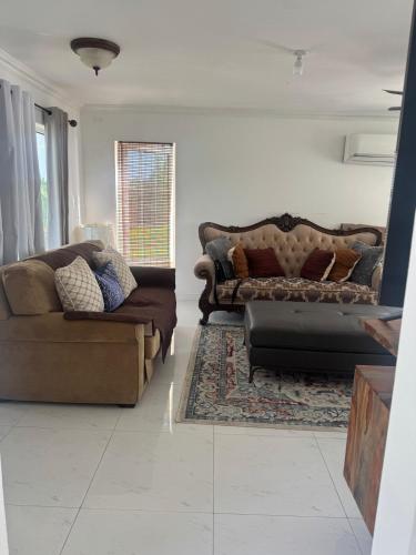 a living room with two couches and a couch at Sunset Serenity 2BR Oceanview Beach & Pool Access 
