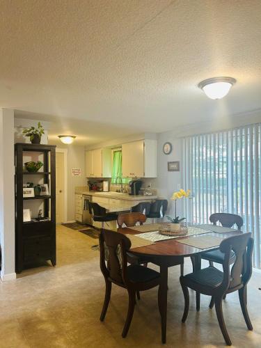 a dining room with a table and chairs and a kitchen at Emerald City 3 Bedroom 1 bath Home in Eugene
