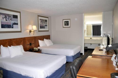 a hotel room with two beds and a couch at Days Inn by Wyndham Luray Shenandoah in Luray