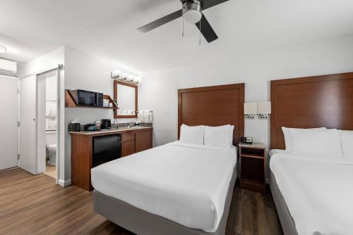 a hotel room with two beds and a kitchen at Comfort Inn Gaslamp Convention Center in San Diego